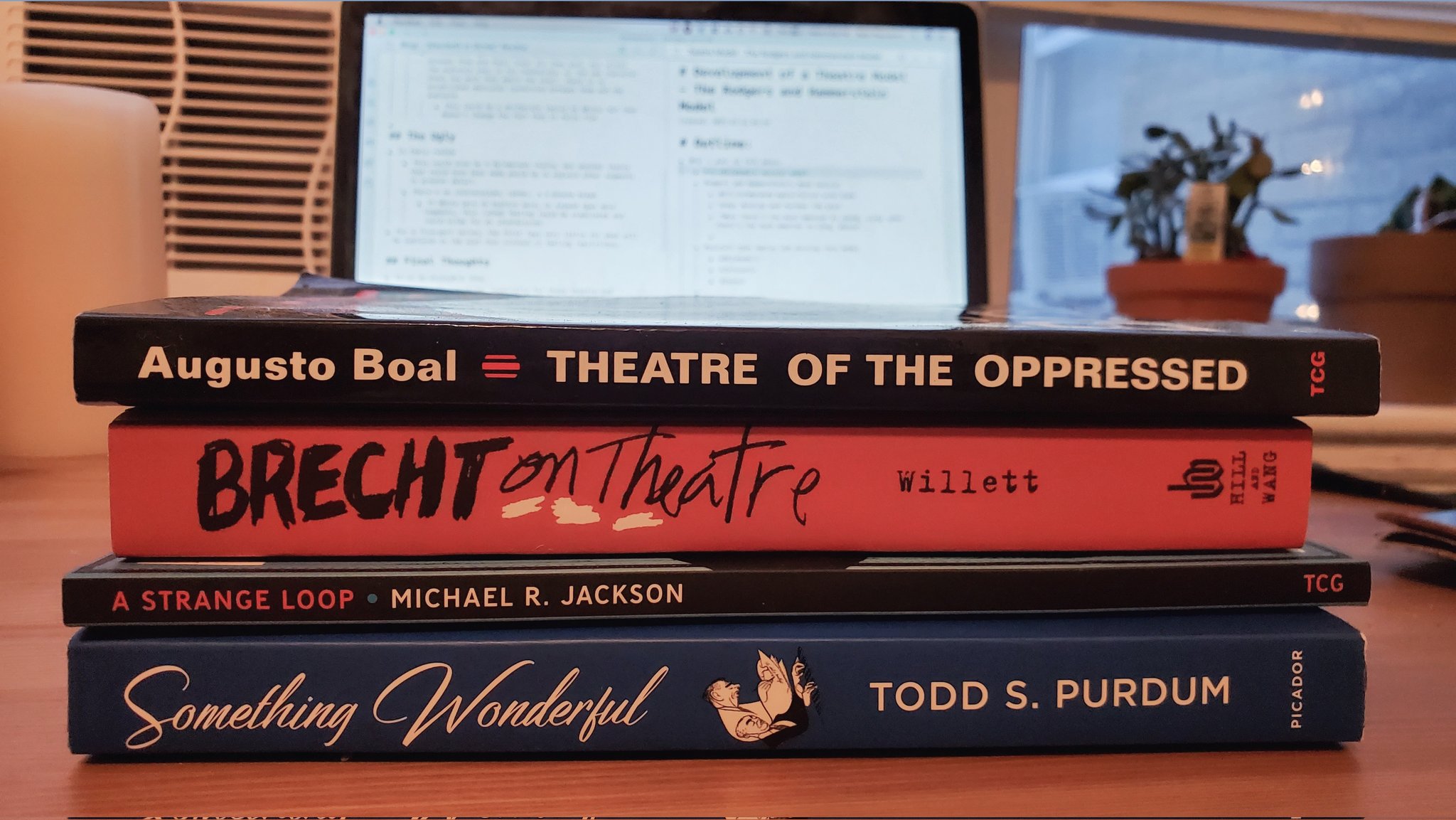 Stack of theatre books, including "Theatre of the oppressed," "Brecht on Theatre," "A Strange Loop," and "Something Wonderful"