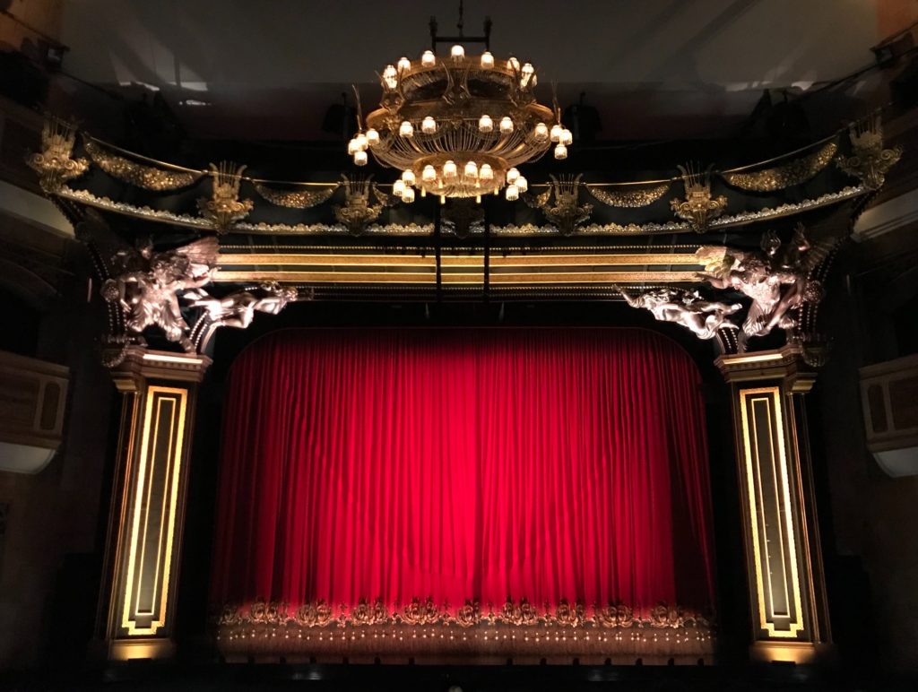 Proscenium stage with red curtain drawn